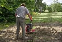 Gardener working with a tiller